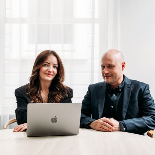 Christine and Mike Westbury of Blackjet working together at a table with a laptop